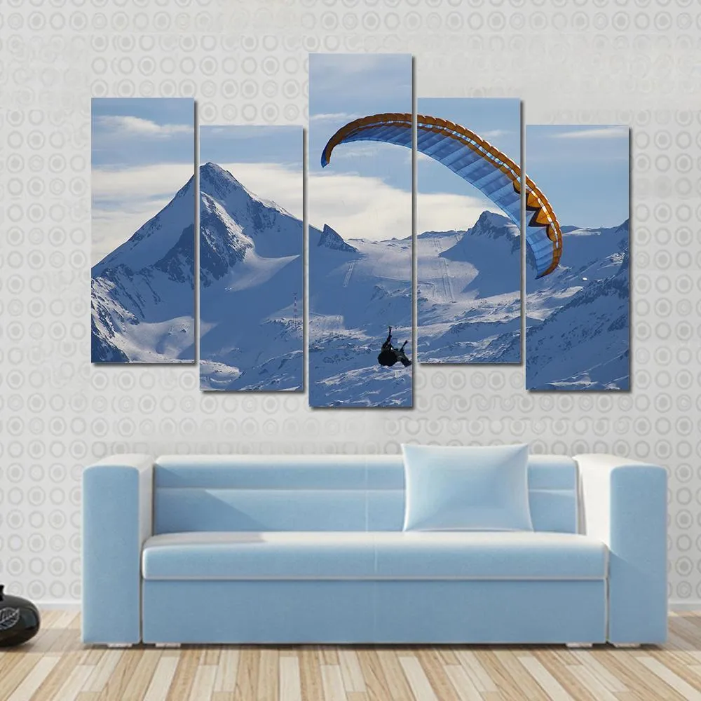 Paragliding Over Mountain In Winter Canvas Wall Art